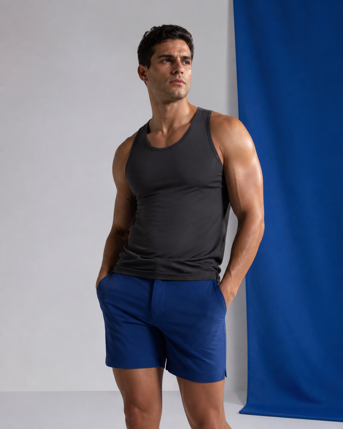 Adult male model in body-conscious performance apparel in a cool neutral studio