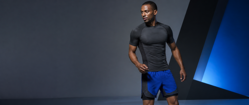 Adult male model wearing fitted cobalt and charcoal activewear