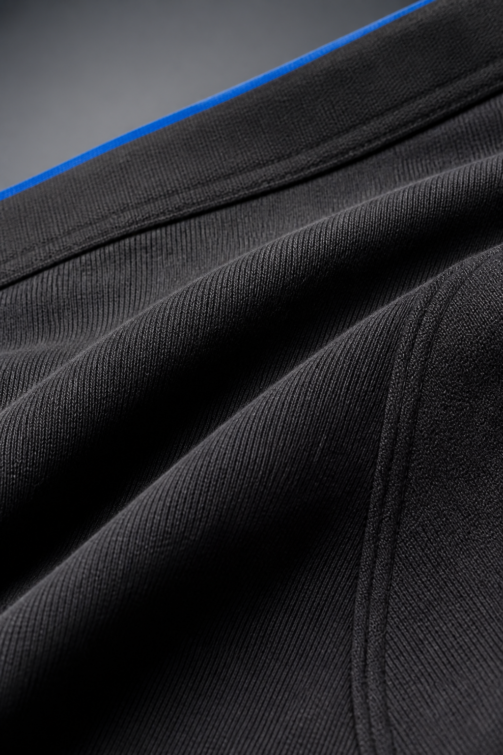 Macro detail of charcoal stretch-knit seamless boxer brief fabric