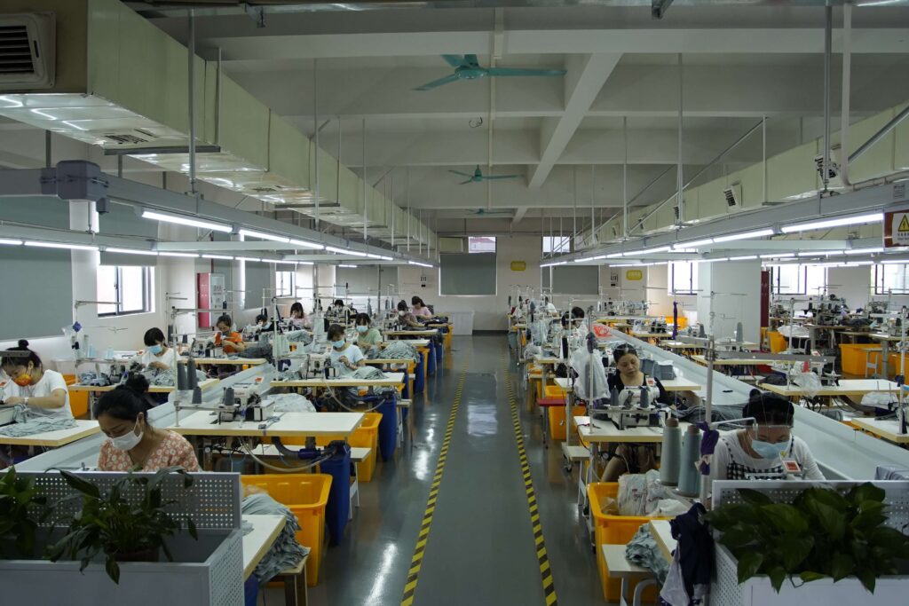 Production staff working at sewing stations in the Shenzhen workshop