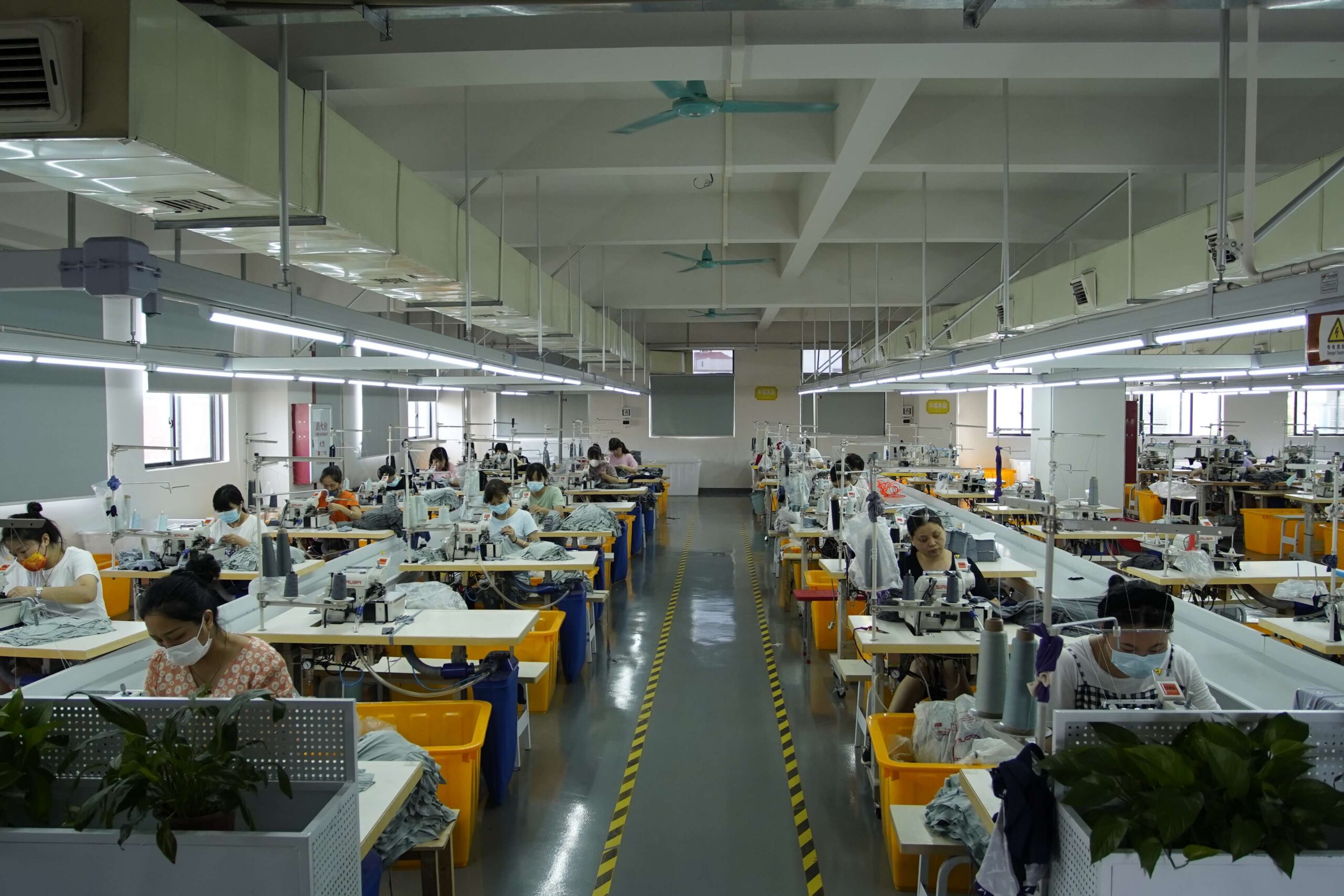 Production staff working at sewing stations in the Shenzhen workshop
