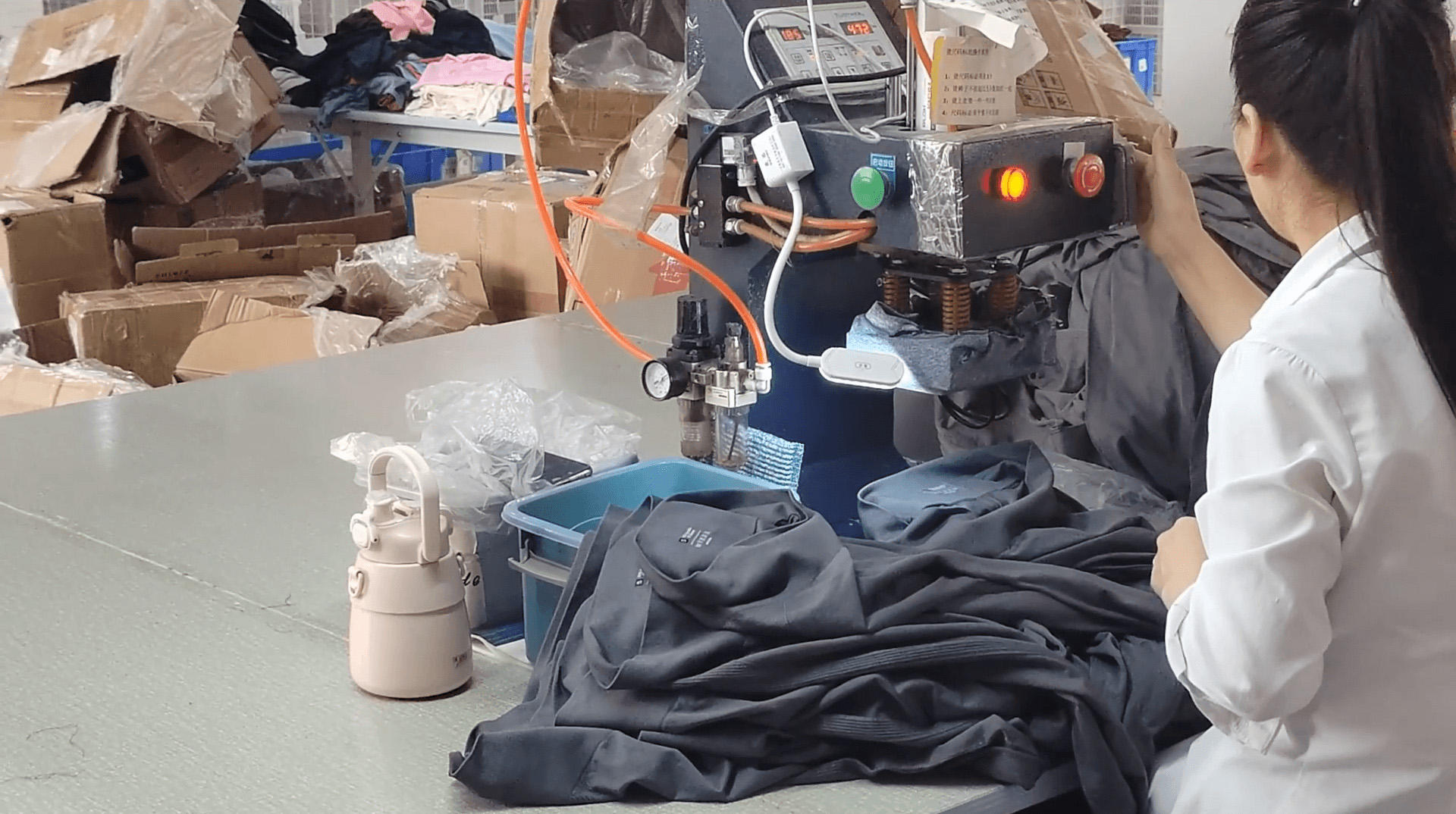 Operator using a garment heat press for a brand application example in Yiwu